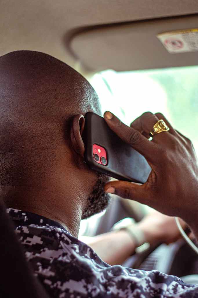 man talking on phone in car